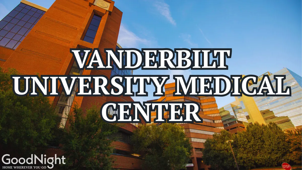 The exterior shot captures the Vanderbilt University Medical Center building surrounded by lush greenery, with the city skyline in the background. The scene conveys the proximity to academic hubs and the energetic, innovative atmosphere of the neighborhood.