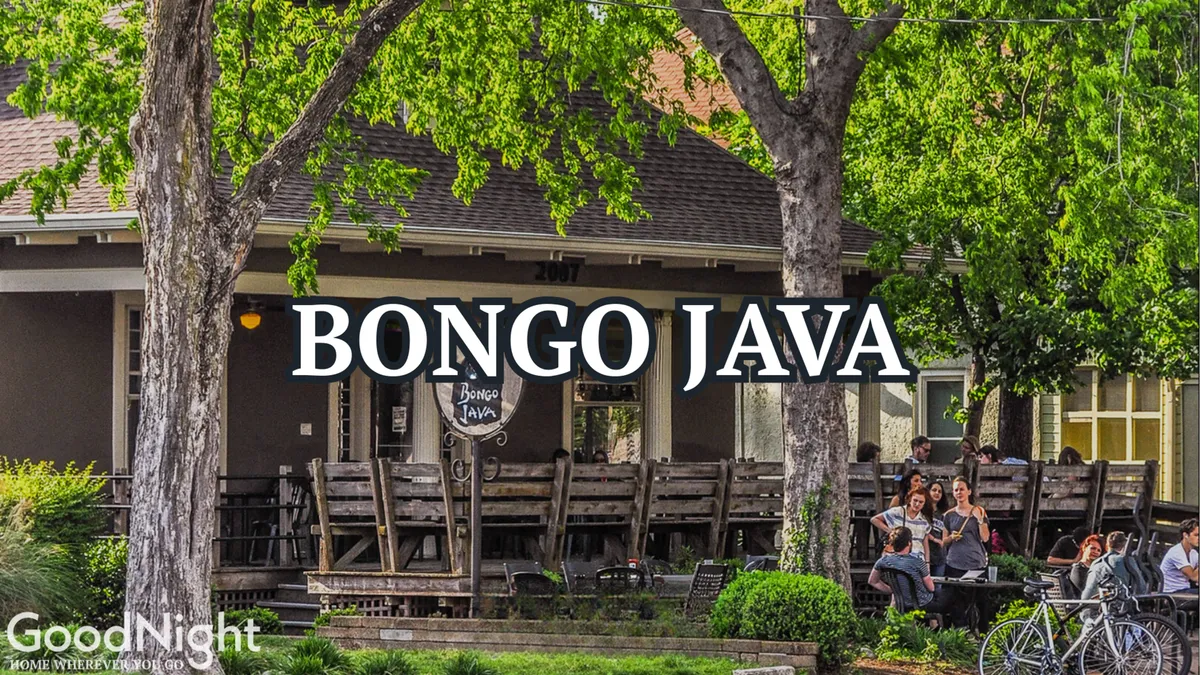 The exterior of Bongo Java, a popular local coffee shop, featuring outdoor seating where people are socializing and enjoying drinks, framed by inviting signage and sidewalk greenery.