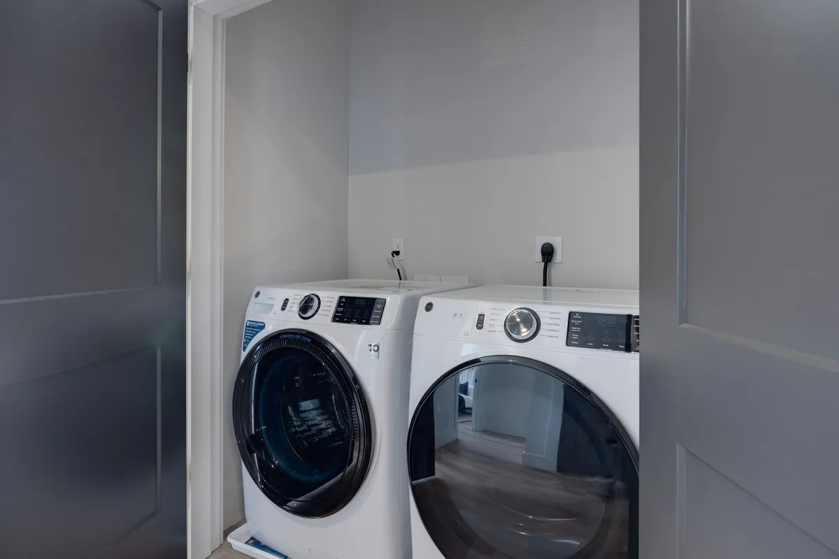 This image showcases a modern in-unit laundry area with a washer and dryer set, organized in a compact and efficient space designed for daily convenience. The setting exudes practicality and cleanliness, supporting effortless routines.